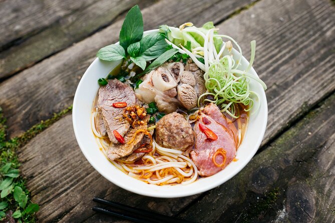 12 Tasting Street Food & Sightseeing By Scooter with Student - Starting with pho on Mac Dinh Chi Street