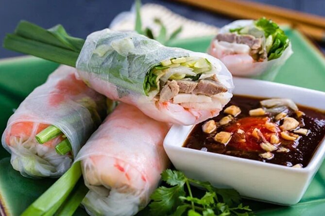 12 Tasting Street Food & Sightseeing By Scooter with Student - Old apartments and a neighborhood pagoda