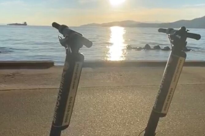Explore Stanley Park on Electric Scooters - Siwash Rock beside the forest and water