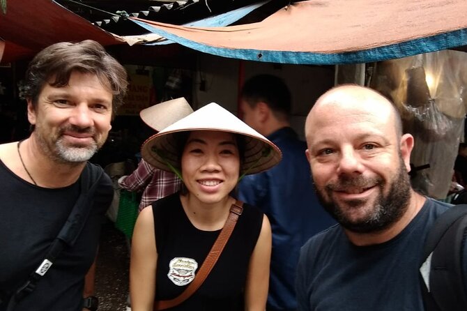 Hanoi Street Food tour by Scooter – Local Experience - Stop one: a traditional market and Hanoi’s evening rhythm