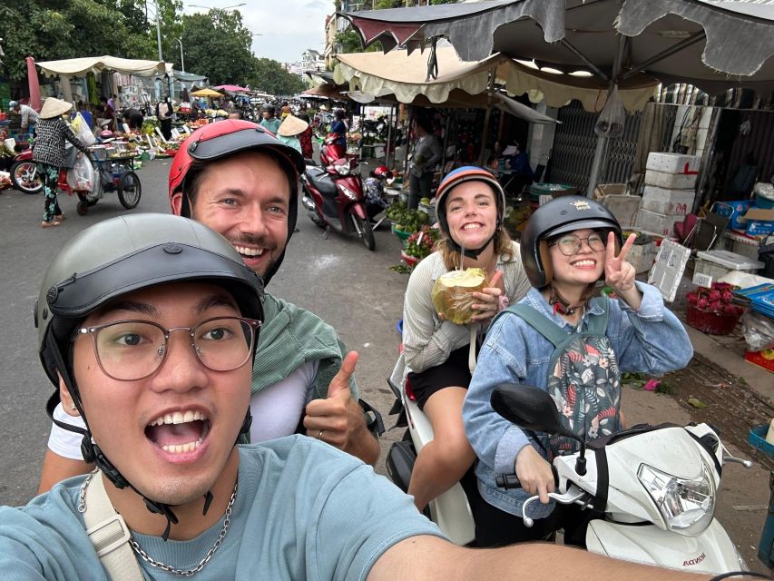 HCM City: Sightseeing Tour with Coffee and Fruit by Scooter - Walking through an old apartment area in District 3